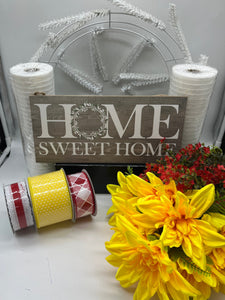 Wreath kit with white frame, two rolls of white mesh, a neutral sign that sates "Home Sweet Home", red gypso, yellow dahlias and three coordinating rolls of ribbon in yellow, white and red. 